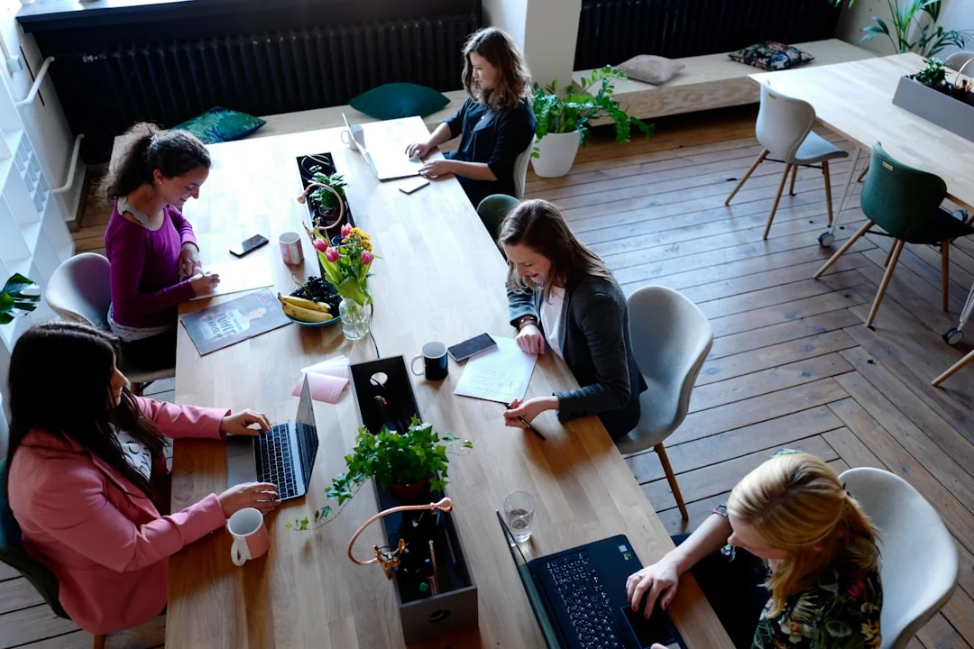 A diverse team engaged in discussion during a collaborative office meeting.